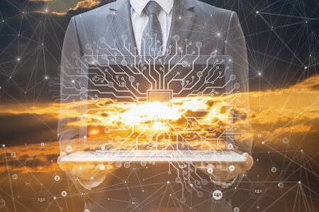 Business man holds laptop on artificial intelligence background.