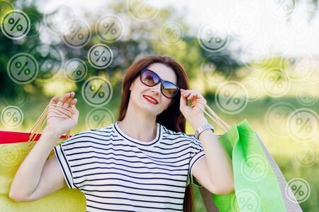 Woman with shopping bags on the background of flying interest.