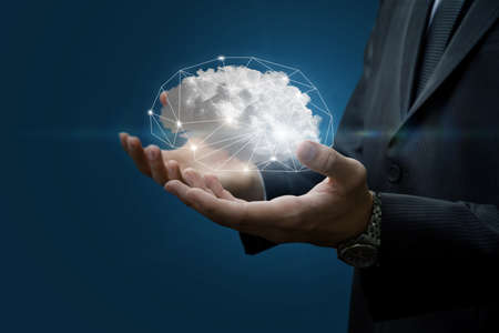 Hands of a businessman show the brain in the form of a cloud on a blue background.