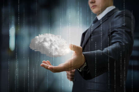 Businessman shows the brain as cloud computing on a blurred background.の写真素材