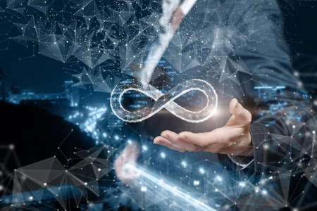 Unlimited internet concept. Business woman shows the infinity sign on the background of the city.の写真素材