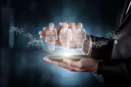 Businessman demonstrates human resources on a tablet on a blurred background.の写真素材