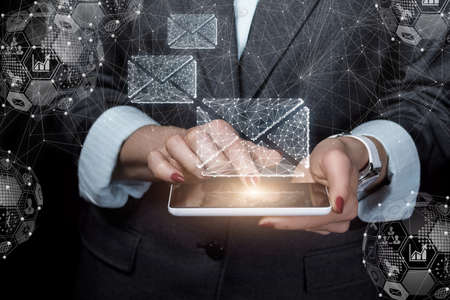Email delivery concept. Business woman working on a tablet with email.