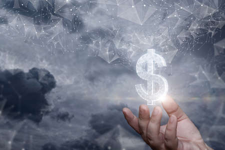 The hand shows a hologram of the dollar emerged from the network on a blurred background.の写真素材