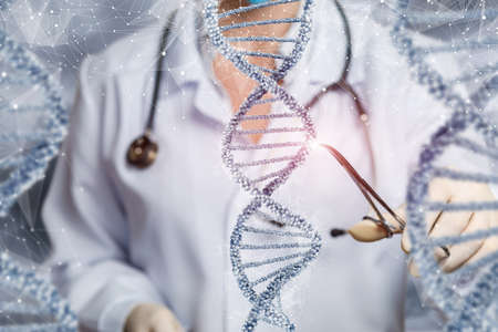 The doctor examines the DNA molecule with a clamp on a blurred background.の写真素材