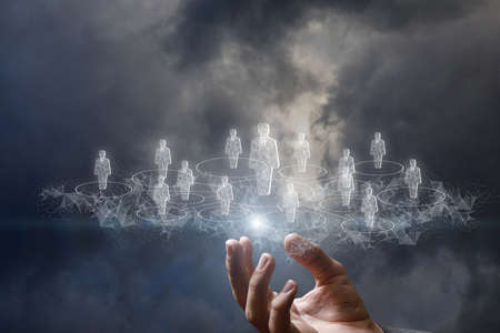 The hand shows the holograms of human resources on the background of the sky.