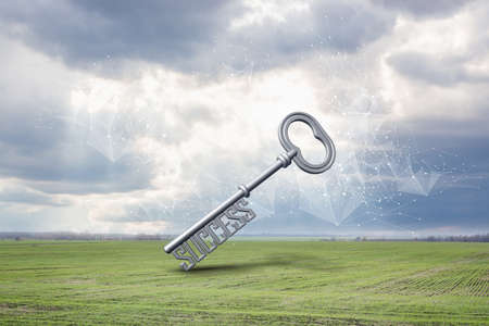 Big key of success against the background of the field and sky.の写真素材