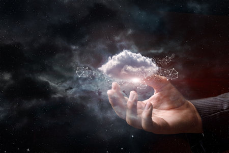 Hand shows clouds of data on the background of outer space.の写真素材