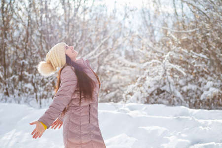 Happy woman smiling on background of winter forest.の写真素材