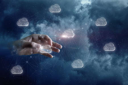 Hand in outer space clicks hologram data storage cloud.の写真素材
