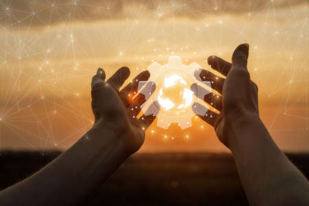 Hands show the mechanism of circulation of substances in nature against the background of a sunny...