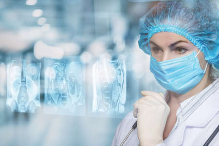 Doctor examines pictures of internal organs on a virtual screen.の写真素材