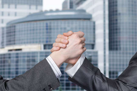 Businessmen successful teamwork concept. Friendly handshake on blurred background.の写真素材
