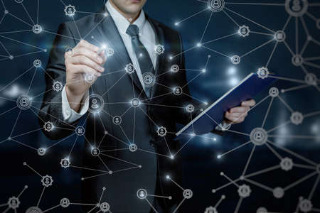 Business man working in the network connection on a dark background.の写真素材