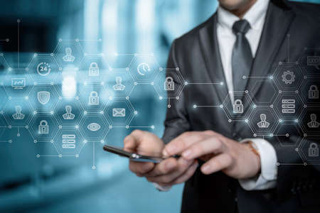 Business man working in security system on virtual screen and phone.の写真素材