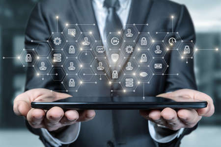 Business man shows structure on tablet on blurred background.