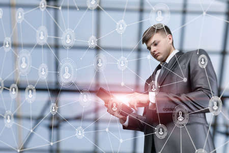 Young businessman working on tablet in business online.