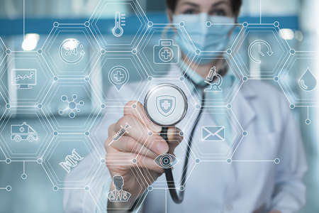 Medical care concept. Medical worker in mask listens to the of medical icons.の写真素材