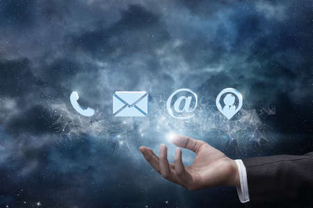 Hand shows contacts on the background of the network and space.の写真素材