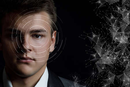 Concept of diagnosis and treatment and vision examination.A man has an eye scanned on a black...