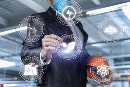 Civil engineer draws a diagram of energy production on a blurred background.の写真素材