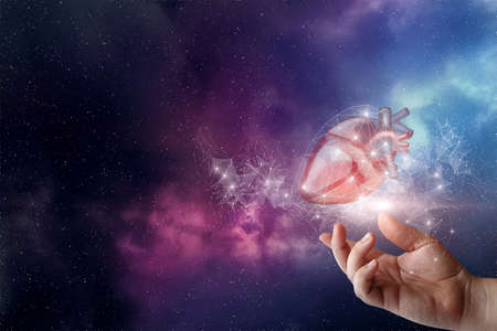 Hand shows the heart on the background of the cosmos in the network connection.