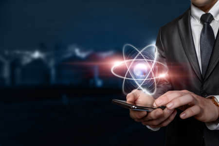 Smart energy management concept. Businessman shows there on a mobile device.の写真素材