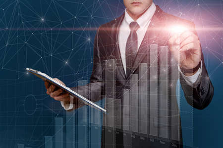 Business man working with financial growth graph on blue background.の写真素材