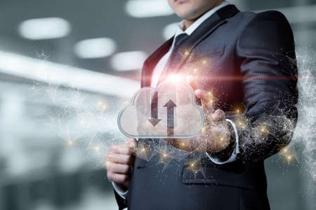 Business man download data from cloud computing on blurred background.の写真素材