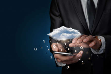 On the phone business man working with cloud computing with binary code on blue background.