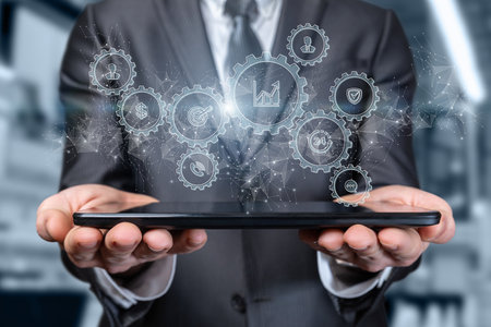 Business man shows the mechanism of business management on the tablet.の写真素材