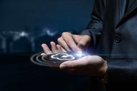 Business man download information in cloud computing on a mobile device.
