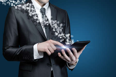 Business man working with mail on tablet on blue background.の写真素材