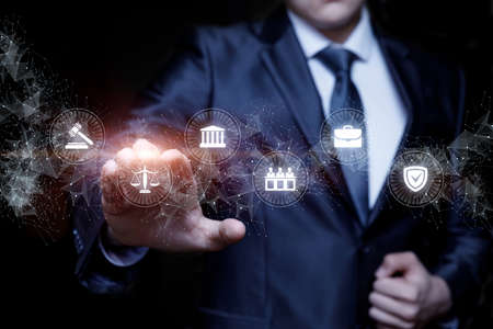 Lawyer clicks on legal icons on a dark background.の写真素材