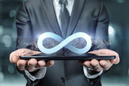 Business man showing infinity sign on tablet.の写真素材