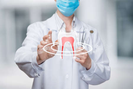 The dentist puts protection on the tooth against caries and bacteria.の写真素材