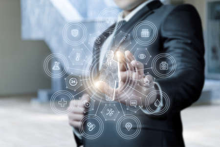 Medical insurance concept. A man clicks on a virtual screen on a health insurance structure.
