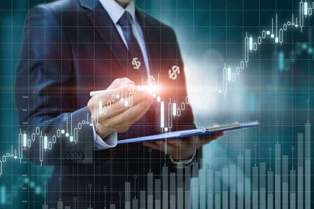 Trader analyzes the graph of profit growth on a blurred background.