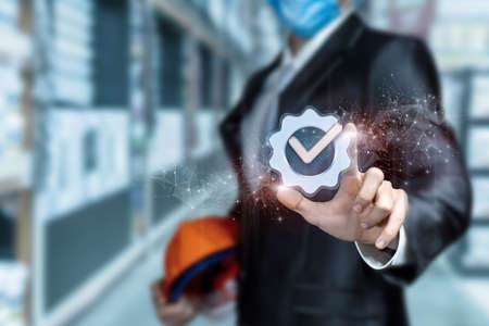 Civil engineer clicks on a job well done icon on a blurred background.