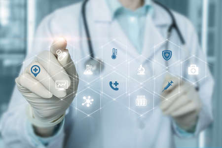 Doctor working on a virtual computer screen on a blurred background.