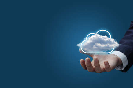 Business man showing cloud computing on blue background.