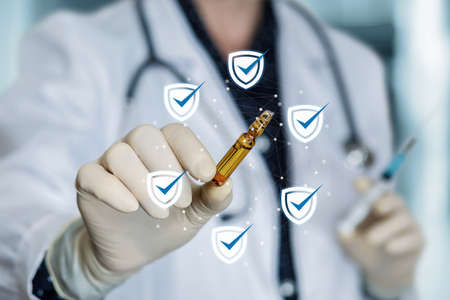 Doctor shows a vaccine that will protect against the spread of the virus.の写真素材