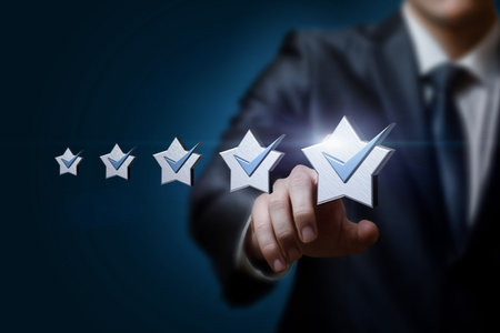 Business man clik on a five star rating on a blue background.の写真素材