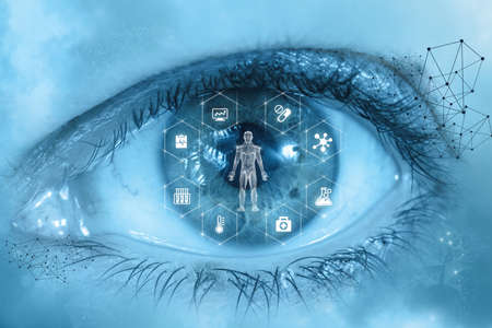 The concept of observation and treatment of patients illnesses. The eye looks at the virtual screen the patient.の写真素材