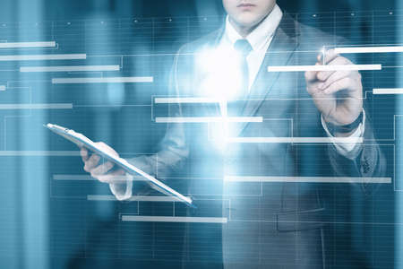 Business man work with a project schedule plan on a virtual computer screen.の写真素材