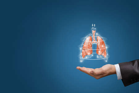 Concepts of lung saturation and air circulation in the lungs. Hand shows lungs on blue background.