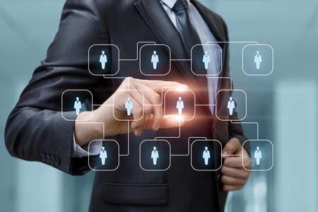 Business man chooses from human resources employee to perform task on blurred background.