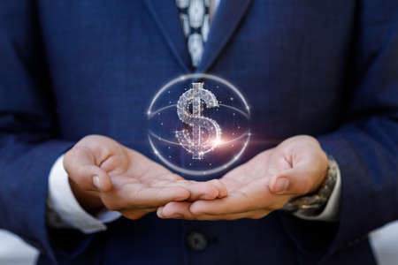 Investment support concepts. Businessman supports dollar hologram on blurred background.の写真素材