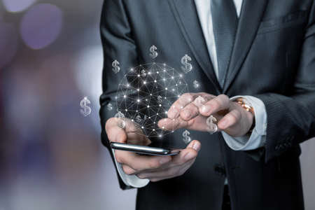 A business man works online by phone in the foreign exchange market.の写真素材