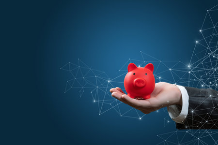 Businessman shows a piggy bank on the background of the network.の写真素材